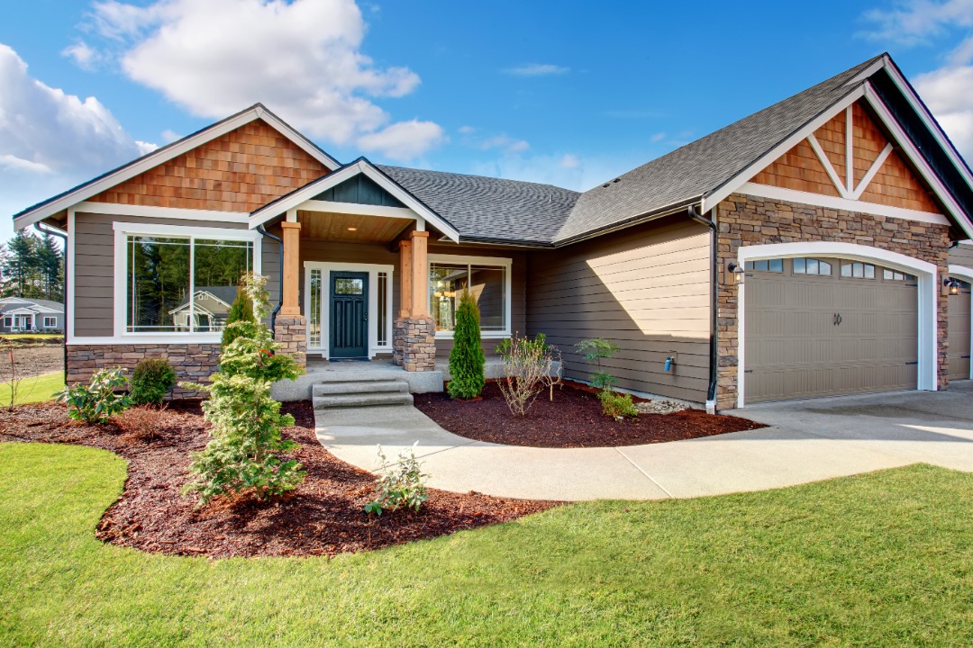 A beautiful home with new mulch installed right outside the front door.